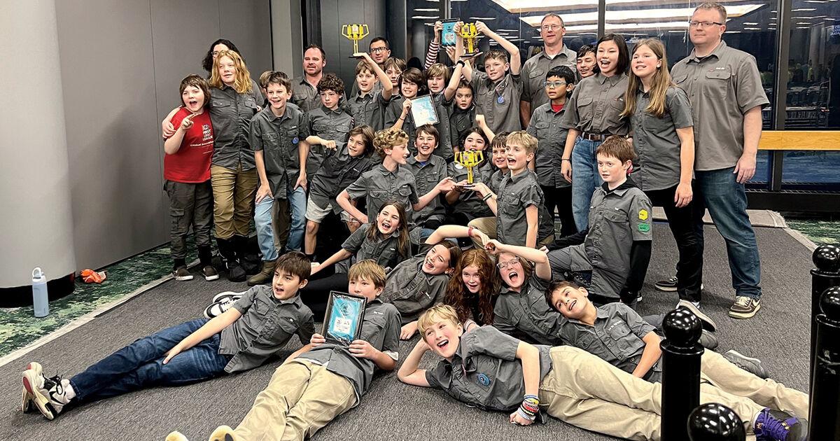 Robocats FLL team celebrating with trophies at competition